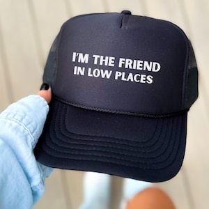 Funny country trucker hat with phrase I’m the Friend in Low Places, unisex adjustable mesh cap, western humor gift for men and women