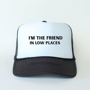 Funny country trucker hat with phrase I’m the Friend in Low Places, unisex adjustable mesh cap, western humor gift for men and women