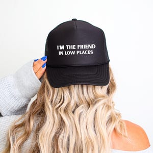 Funny country trucker hat with phrase I’m the Friend in Low Places, unisex adjustable mesh cap, western humor gift for men and women