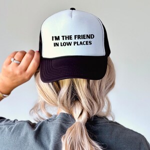 Funny country trucker hat with phrase I’m the Friend in Low Places, unisex adjustable mesh cap, western humor gift for men and women