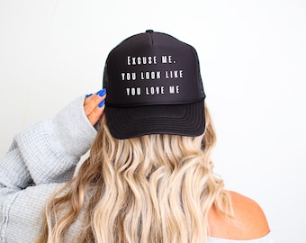 May include: Black trucker hat with white text that reads "Excuse me. You look like you love me."