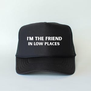 Funny country trucker hat with phrase I’m the Friend in Low Places, unisex adjustable mesh cap, western humor gift for men and women