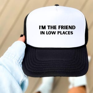 Funny country trucker hat with phrase I’m the Friend in Low Places, unisex adjustable mesh cap, western humor gift for men and women