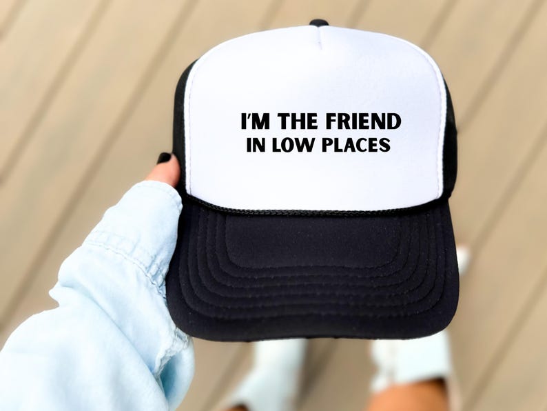 Funny country trucker hat with phrase I’m the Friend in Low Places, unisex adjustable mesh cap, western humor gift for men and women