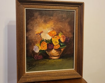 Oil painting of flowers in a wooden frame