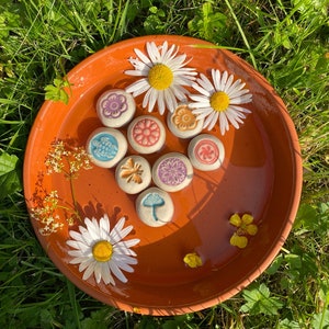 Könnte beinhalten: Ein Set aus drei Keramikbechern mit gesprenkelter, matter Oberfläche. Die Becher sind in Creme-, Hellgrau- und Dunkelgrautönen gehalten. Jeder Becher hat ein schlichtes, minimalistisches Design.
