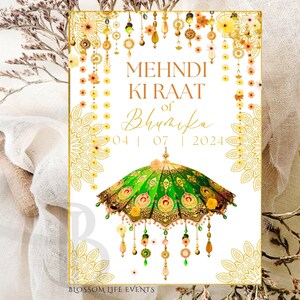 May include: A white card with gold accents and a green and gold umbrella design. The text on the card reads "Mehndi Ki Raat of Bhyarika 04 | 07 | 2024".