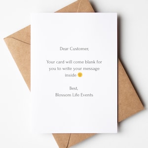 May include: A white greeting card with black printed text that reads: Dear Customer, Your card will come blank for you to write your message inside, followed by a yellow smiley face emoji and the signature, Best, Blossom Life Events.