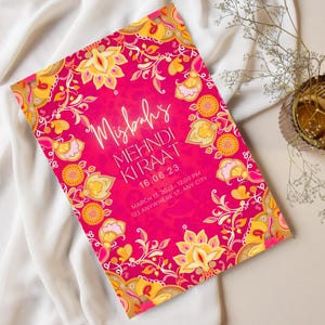 May include: A pink and gold invitation with intricate floral designs. The text reads "Misbahs Mehndi Kiraat 16.06.23 March 13, 2022 - 12:00 PM 123 Anywhere St, Any City"