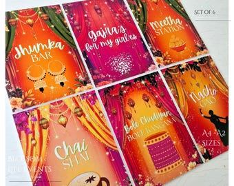 以下が含まれることがあります： 「Jhumka Bar」や「Chai Shai」などのテキストが書かれた、6枚セットのカラフルなイベントサイン。装飾的なデザインと花のアクセントが特徴です。A4-A2サイズで、お祝い事に最適です。