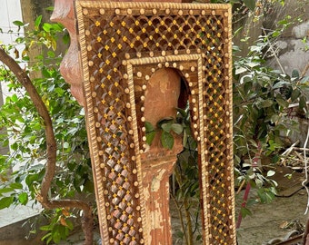 May include: A rectangular wooden frame with a lattice design and gold accents. The frame is made of wood and has a distressed finish. The frame is empty and ready to be used for a mirror or artwork.