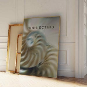 May include: A gold framed poster with a swirling abstract design in shades of brown, blue, and white. The poster has the text "CONNECTING" at the top and the words "BODY", "MIND", "HEART", and "SOUL" arranged in a circle around the design.