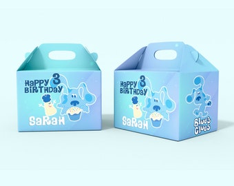 May include: Two blue and white favor boxes with a handle. The boxes feature a cartoon dog with a cupcake and the text "Happy Birthday" and "Sarah". One box also has the text "Blue's Clues".