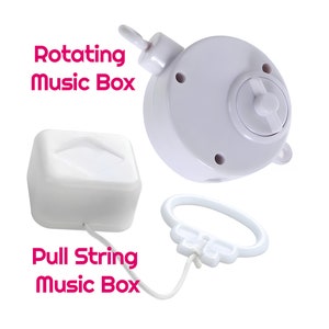 May include: Two white music boxes. One is a pull-string music box and the other is a rotating music box.