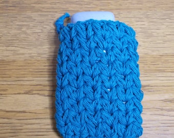 May include: A teal blue crocheted soap sack with a white bar of soap inside.