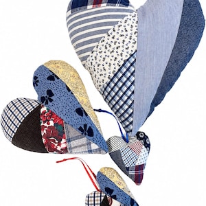May include: Four heart-shaped fabric ornaments in varying sizes, constructed from patchwork panels of blue, white, red, and yellow textiles. The patterns include plaid, stripes, floral prints, and solid textures, with attached ribbons for hanging.