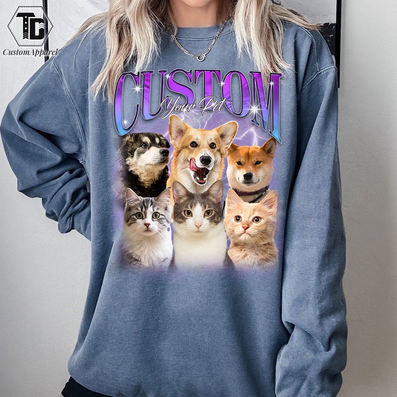 May include: A blue sweatshirt with the text "CUSTOM Your Pet" in a purple and white gradient. The sweatshirt features a collage of five animals: a corgi, a husky, a Shiba Inu, and two cats.