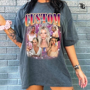 May include: Gray t-shirt with a custom design featuring the word "CUSTOM" in a gradient font. The design includes multiple images of a woman. The shirt has a vintage, washed look.