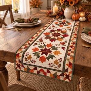 May include: A rectangular table runner featuring a cream-colored background with a repeating pattern of large, multi-pointed stars composed of autumn-colored maple leaves in shades of orange, red, yellow, and dark green, accented with acorns and berries.
