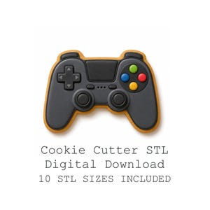 May include: A video game controller shaped cookie with a dark grey surface, black joysticks, and four coloured buttons in green, blue, red, and yellow. The text below reads: Cookie Cutter STL Digital Download 10 STL SIZES INCLUDED.