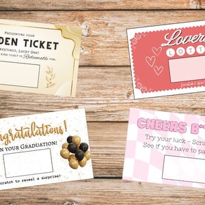 May include: Four scratch-off cards with various designs and text. One reads "Golden Ticket," another "Lovers Lotto," a third "Congratulations! On Your Graduation!," and the last "Cheers B*tches." Each card has a blank scratch area.