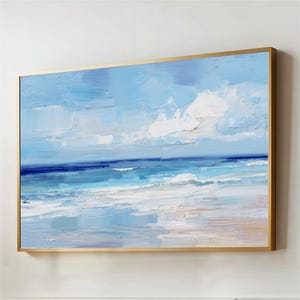 The image is a framed painting depicting a serene ocean scene with a blue sky and white clouds.