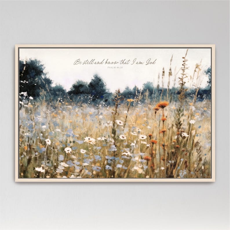 The image is a painting of a field filled with wildflowers, including daisies and other colorful blooms. The painting is framed and hangs on a wall.