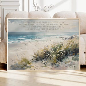 May include: A rectangular wall art print featuring a coastal landscape with sand dunes, white wildflowers, and a blue ocean. The text reads: Trust in the Lord with all your heart, and lean not on your own understanding; in all your ways acknowledge him, and he shall direct your paths. Proverbs 3:5-6.