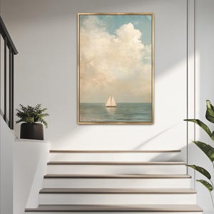 a painting of a sailboat on the ocean, hanging on a white wall above a set of white stairs.
