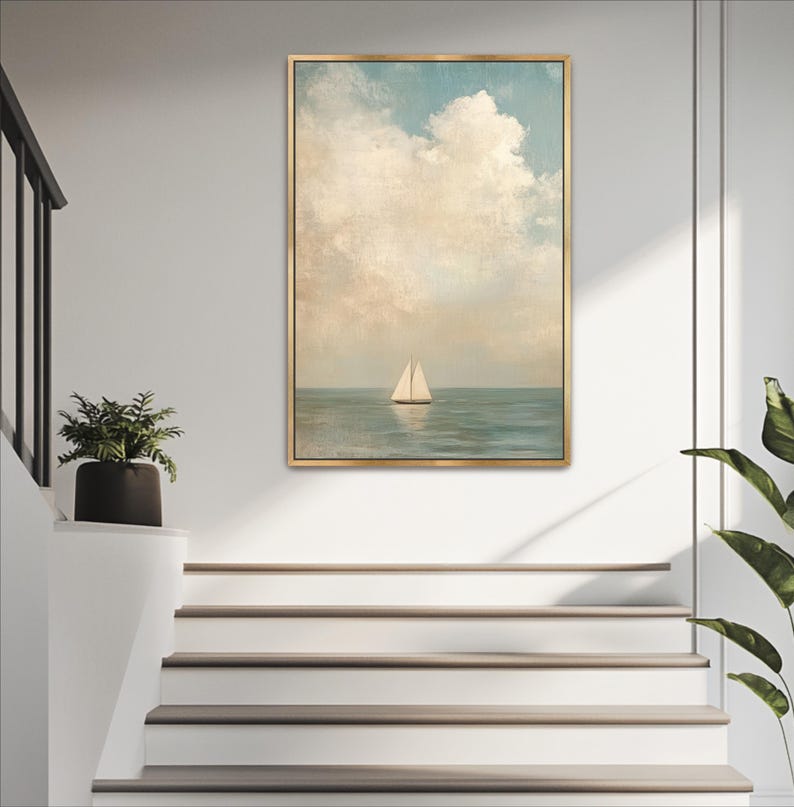 a painting of a sailboat on the ocean, hanging on a white wall above a set of white stairs.