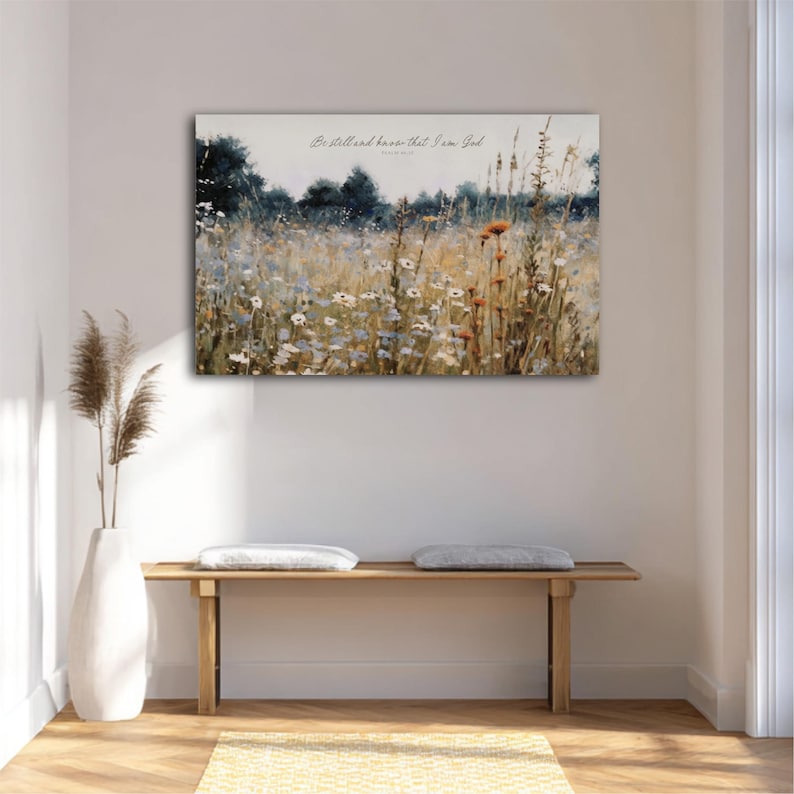 a serene indoor setting with a wooden bench, a white vase, and a painting of a field of flowers hanging on the wall.