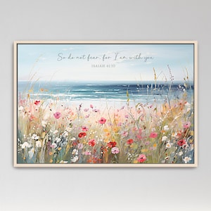 May include: A framed canvas art print depicting a serene beach scene. The artwork features a vibrant field of wildflowers in shades of pink, red, and white, with the ocean in the background. The text "So do not fear, for I am with you" is written across the top.