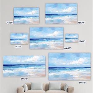 a collection of seven framed paintings depicting a serene beach scene with a blue sky, ocean, and clouds. The paintings vary in size, ranging from 36x24 inches to 48x32 inches. The paintings are arranged in a grid-like pattern on a wall, with each frame showcasing a different perspective of the beach landscape.