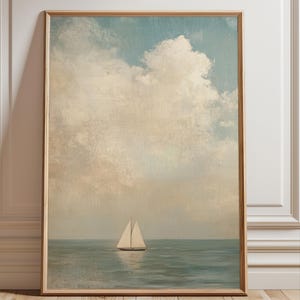 a sailboat on the water, with a cloudy sky in the background.