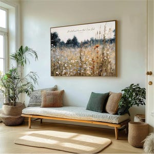 a living room with a large painting of a field of flowers hanging on the wall above a wooden bench with pillows. The room is decorated with potted plants and a rug, creating a cozy and inviting atmosphere.
