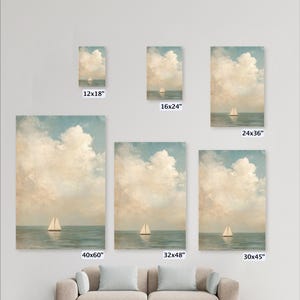 a collection of six framed paintings or prints of a seascape, each varying in size and framing. The paintings are arranged on a wall, with a couch or sofa in the foreground.