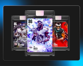 May include: Three football trading cards in protective plastic cases. The center card features Ed Reed holding a trophy with an 86 rating. The left card shows Cam Skattebo with an 85 rating, and the right card displays Jalen Hurts with an 86 rating.