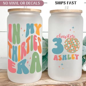 May include: Two frosted glass tumblers with bamboo lids and straws. One tumbler reads "IN MY THIRTIES ERA" in colorful retro font. The other says "chapter 30 Ashley" with a disco ball graphic. A fun gift.