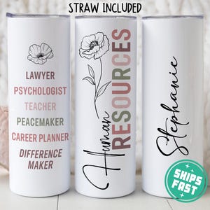 May include: Three white stainless steel tumblers with different designs. The first tumbler has the text "LAWYER, PSYCHOLOGIST, TEACHER, PEACEMAKER, CAREER PLANNER, DIFFERENCE MAKER". The second tumbler has a floral design and the text "Human Resources". The third tumbler has the text "Stephanie".
