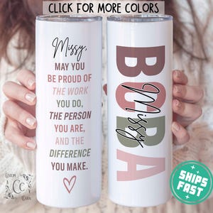 May include: Two stainless steel tumblers with a white background. One tumbler has the text "Missy. May you be proud of the work you do, the person you are, and the difference you make." with a pink heart at the bottom. The other tumbler has the text "BOBA" with the name "Missy" written inside the letters in a cursive font. The letters are in shades of pink, brown, and green.