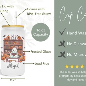 May include: A 16 ounce frosted glass tumbler with a spooky Halloween design featuring a ghost reading a book in a library. The tumbler has a bamboo lid with a silicone ring and comes with a BPA-free straw. The tumbler is lead-free and hand wash only. The text "Abigail" is printed on the tumbler.