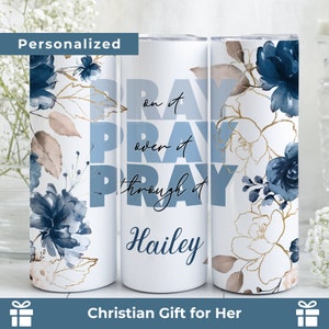 May include: A white tumbler with a blue floral design and the text "Pray on it, Pray over it, Pray through it" and a personalized name.