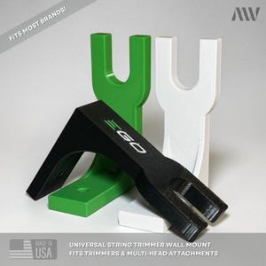 May include: Three wall mount brackets for string trimmers in green, white, and black. The black bracket features the text EGO. Text on the image includes FITS MOST BRANDS!, MADE IN USA, and UNIVERSAL STRING TRIMMER WALL MOUNT FITS TRIMMERS & MULTI-HEAD ATTACHMENTS.