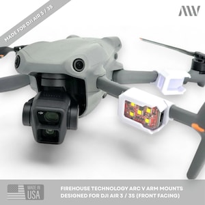 May include: A gray DJI Air 3 drone equipped with white Firehouse Technology Arc V arm mounts. The mounts feature red LED strobe lights and are attached to the front arms. The text MADE FOR DJI AIR 3 / 3S and MADE IN USA are visible.
