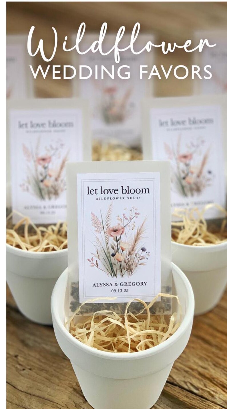 May include: White ceramic pots filled with dried straw, holding packets of wildflower seeds. Each packet features floral illustrations and the text "let love bloom," along with names and a date. The image is labeled "Wildflower WEDDING FAVORS."