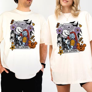 two people wearing white t-shirts with a graphic design depicting characters from the movie "The Nightmare Before Christmas".