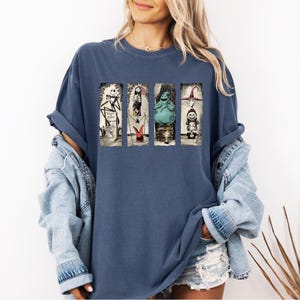 a woman wearing a blue t - shirt with a picture of a woman on it