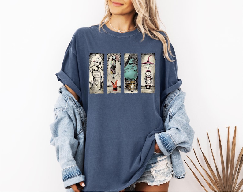 a woman wearing a blue t - shirt with a picture of a woman on it