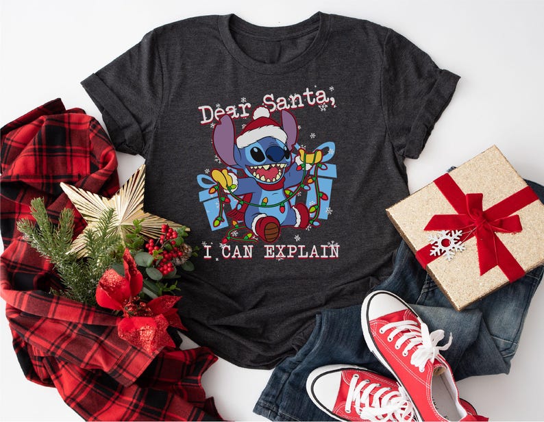 a black t-shirt with a cartoon character and text, along with Christmas-themed items such as a gift box, a red bow, and a pair of red sneakers.