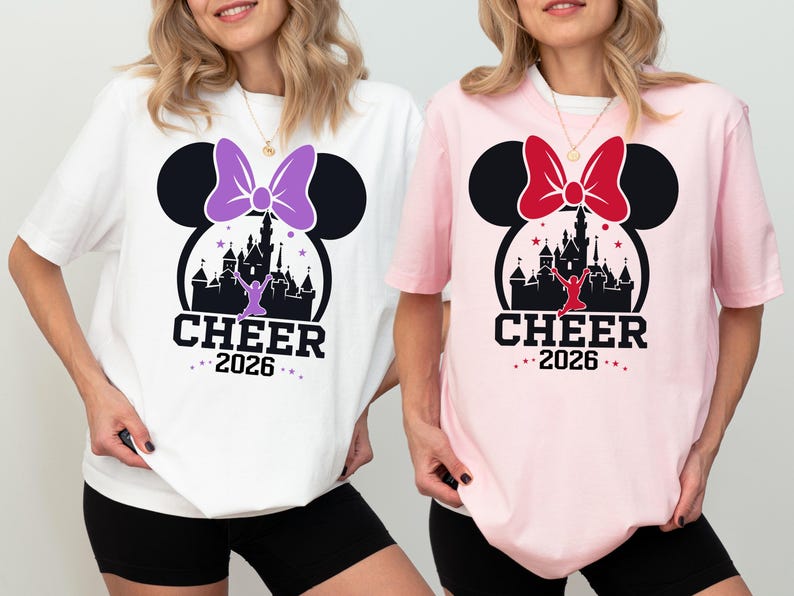 Two women wearing t-shirts with a Disney-themed design, including a castle and Minnie Mouse.